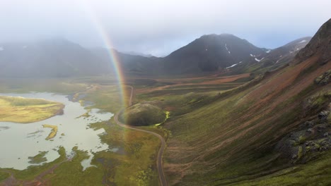 Green-mountains-and-lake-against-cloudy-sky