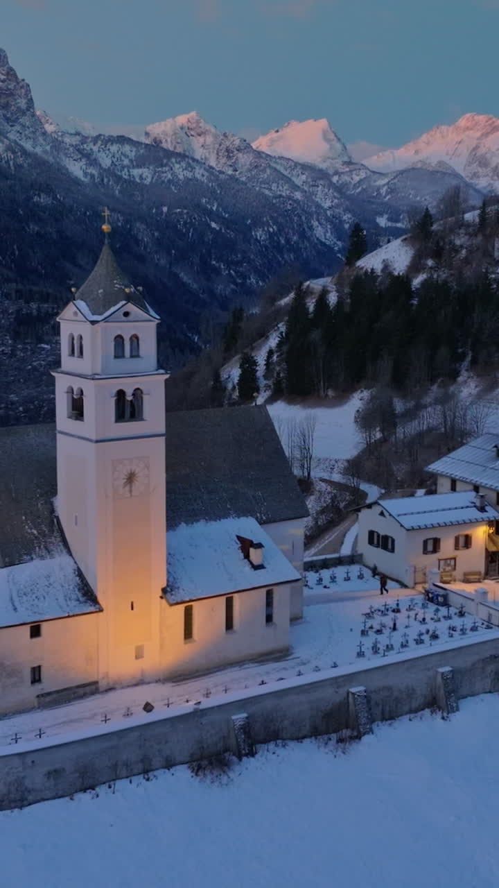 Aerial drone view of the Eglise de Sainte-Lucie in the Colle Santa Lucia comune in Dolomites, Italy. Vertical