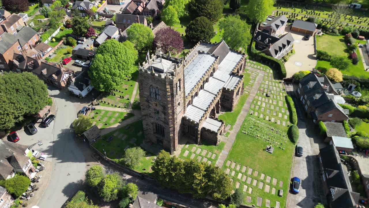 Beautiful St Mary and All Saints Church by drone in the picturesque village of Great Budworth - rotate then pull back from close revealing landscape - Cheshire, UK