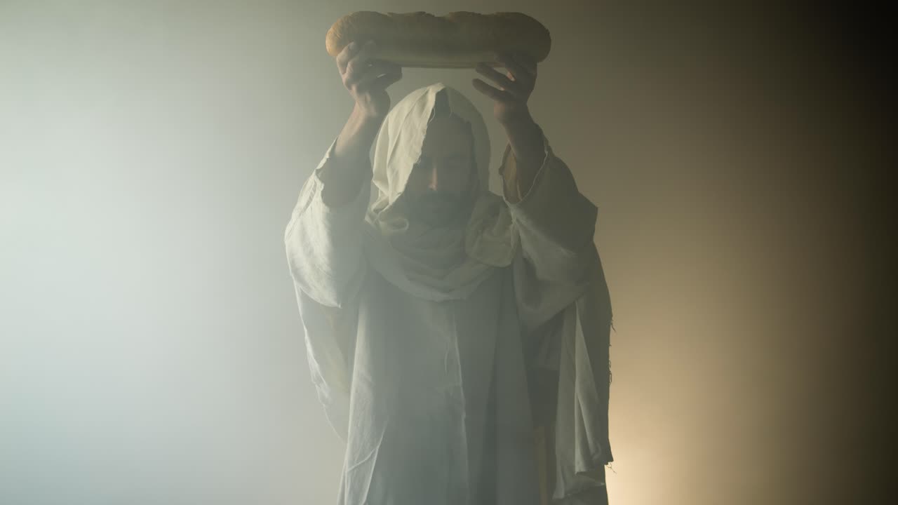 Man holding bread, possible religious scene