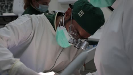 Focused-dentist-treating-teeth-of-patient-in-clinic