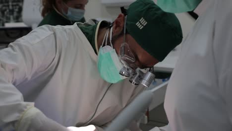 focused dentist treating teeth of patient in clinic