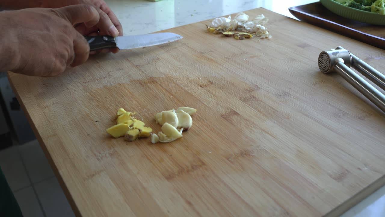 Slicing Fresh Ginger and Garlic on a Cutting Board