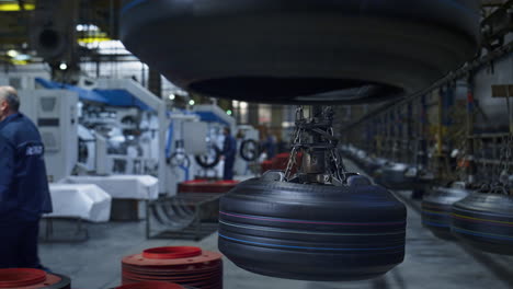 tyre production plant workers at storage facility working with modern machines