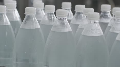 cinta transportadora con botellas de agua potable en una planta de bebidas moderna