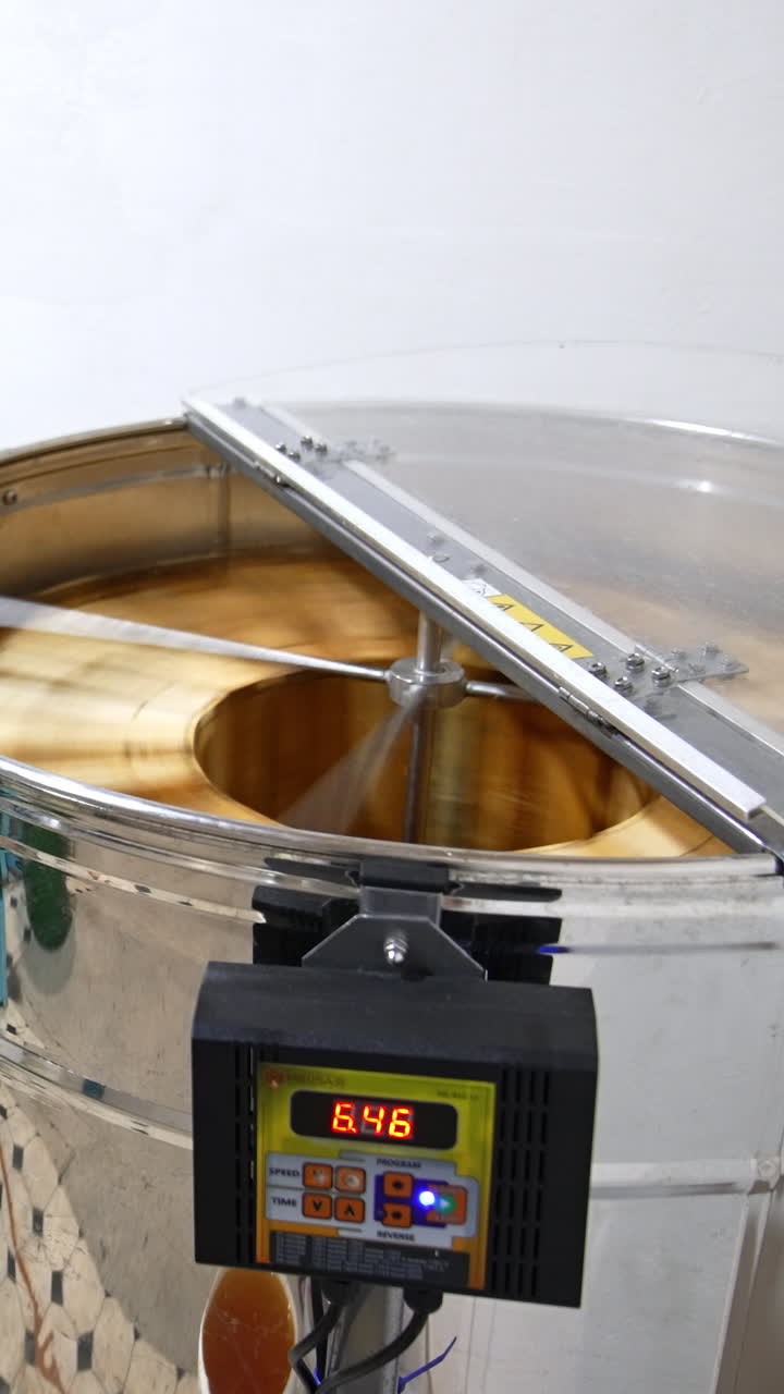 Centifuge honey harvesting. Organic wooden beehive machine. Vertical video