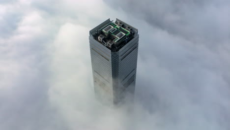 rascacielos icc por encima de las nubes bajas en la niebla matutina