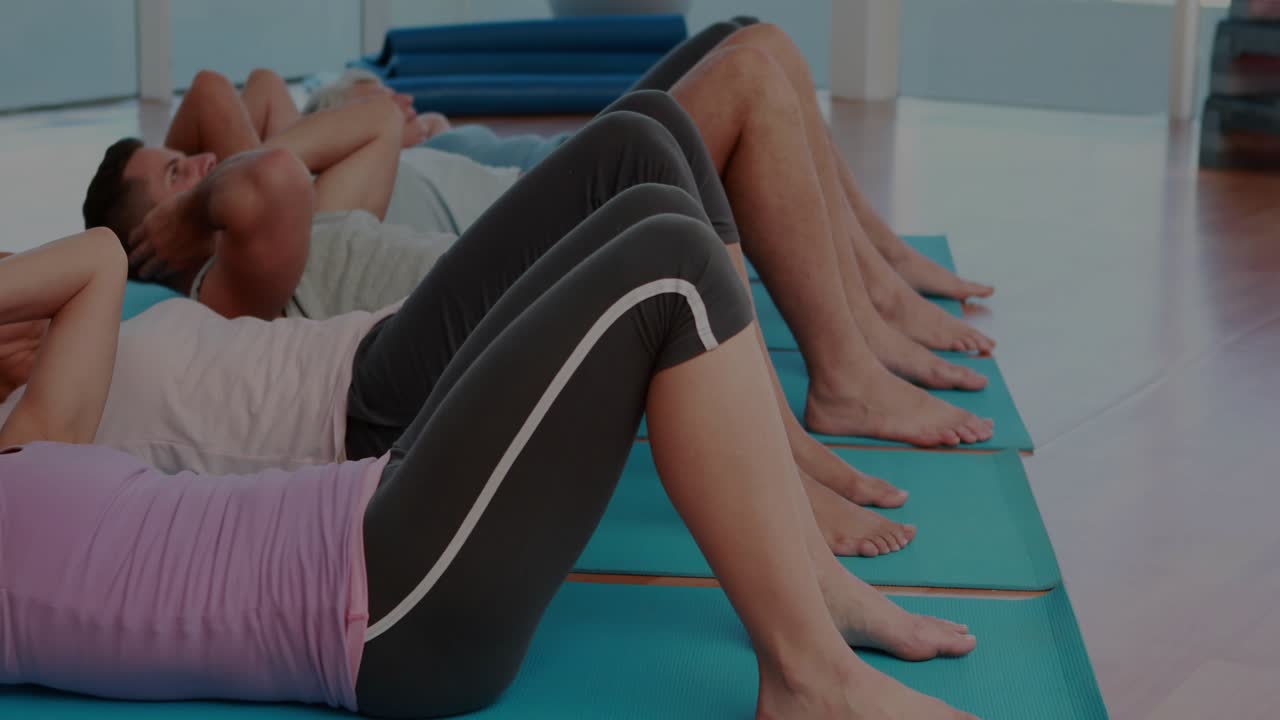 Front woman doing crunches on blue mats on fitness cue, charts overlaying reps to build core
