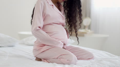 pregnant woman in pink pajamas