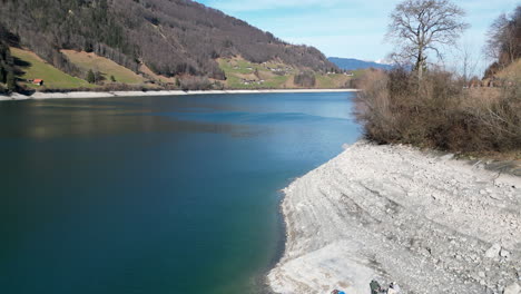 Aerial-of-Glacial-Lake-Beach-at-Lake-Lungern,-Obwalden,-Switzerland