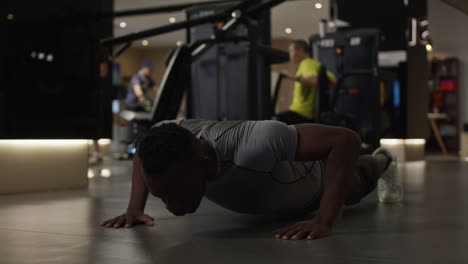 man doing push-ups in a gym