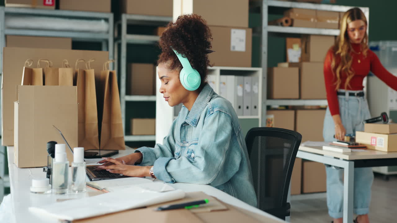 Woman working at a desk with laptop in a small business office