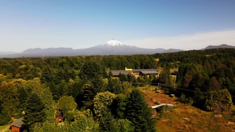 aerial shot of forest and volcano villarica, chile