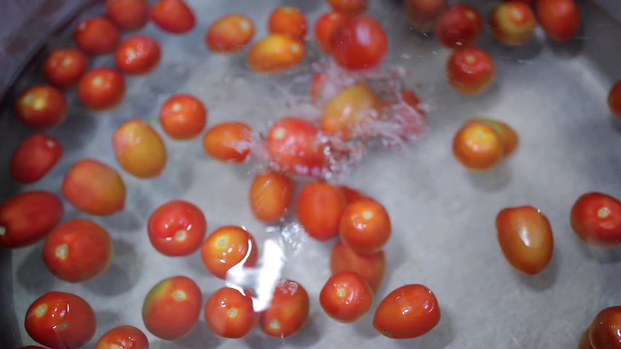 red tomatoes in water boiling