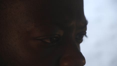 close up of black male's eyes staring intensely at computer