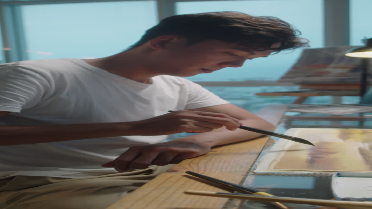 Artist Painting Picture with Watercolors in Studio