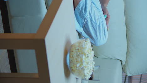 vertical video: speaking on phone holding snacks bowl
