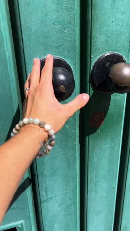 hand on a teal door