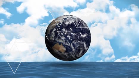 animation of triangles and globe over sky with clouds and sea