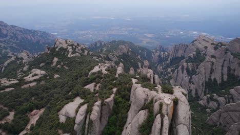 opening shot of the mountains surrounding the monestary of montserrat viewpoint in spain, europe by drone