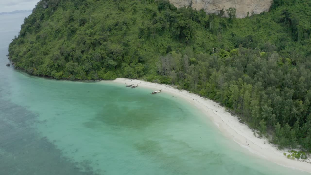 tropical beach with palm trees and boats in thailand