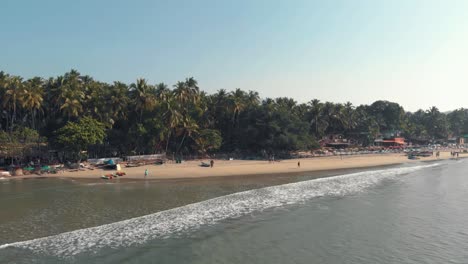 4k aerial drone footage of a beautiful tropic beach with a few visitors at the tourist destination spot of palolem, india