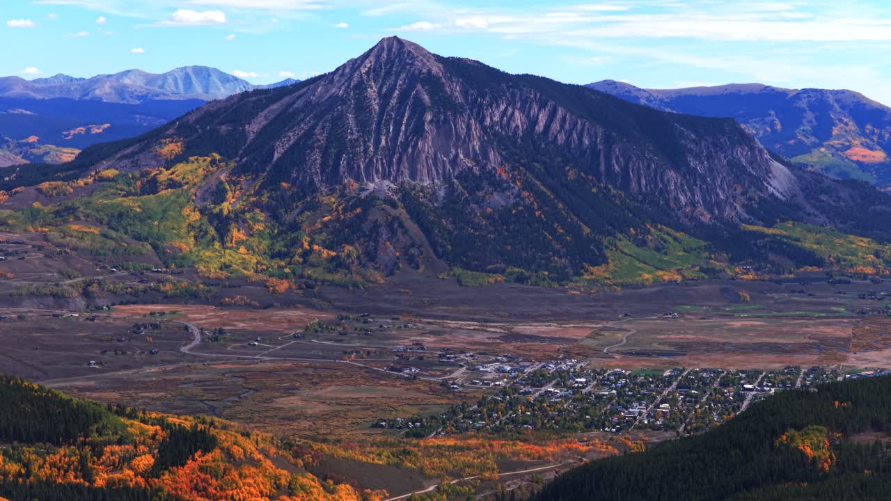 Mount Crested Butte Colorado drone aerial fall Elk Range Rocky Mountains Crested Butte ski resort town autumn Quaking colorful Aspen Trees blue skies clouds Coal Creek Kebler Pass forward circle