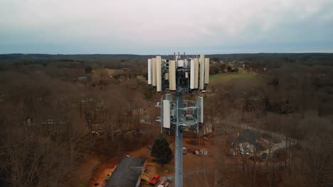 aerial shot rotating around cell phone tower in nature. 4k drone footage
