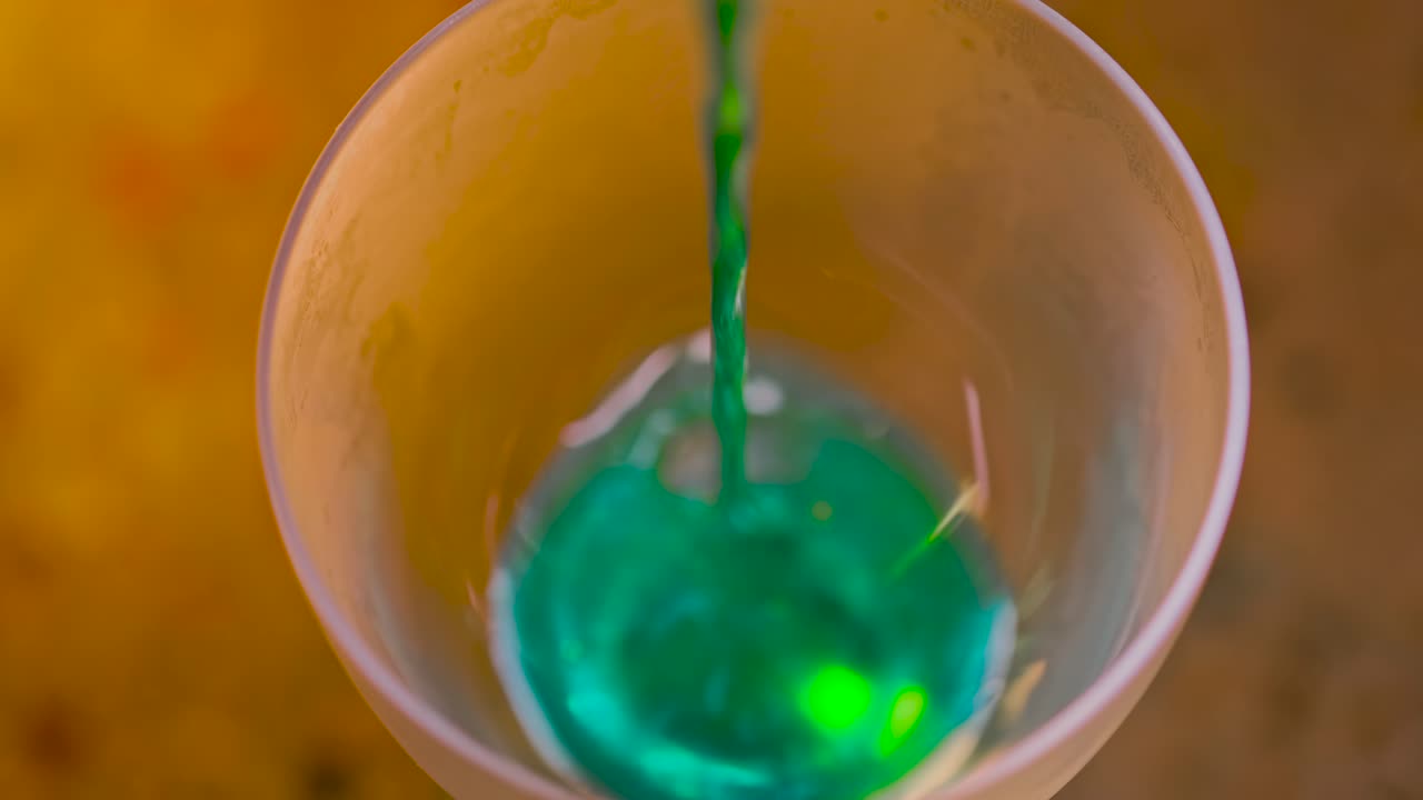 Green Cocktail Being Poured