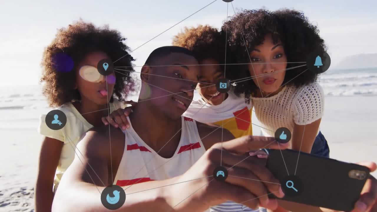 Animation of media icons over happy african american family taking selfie at beach