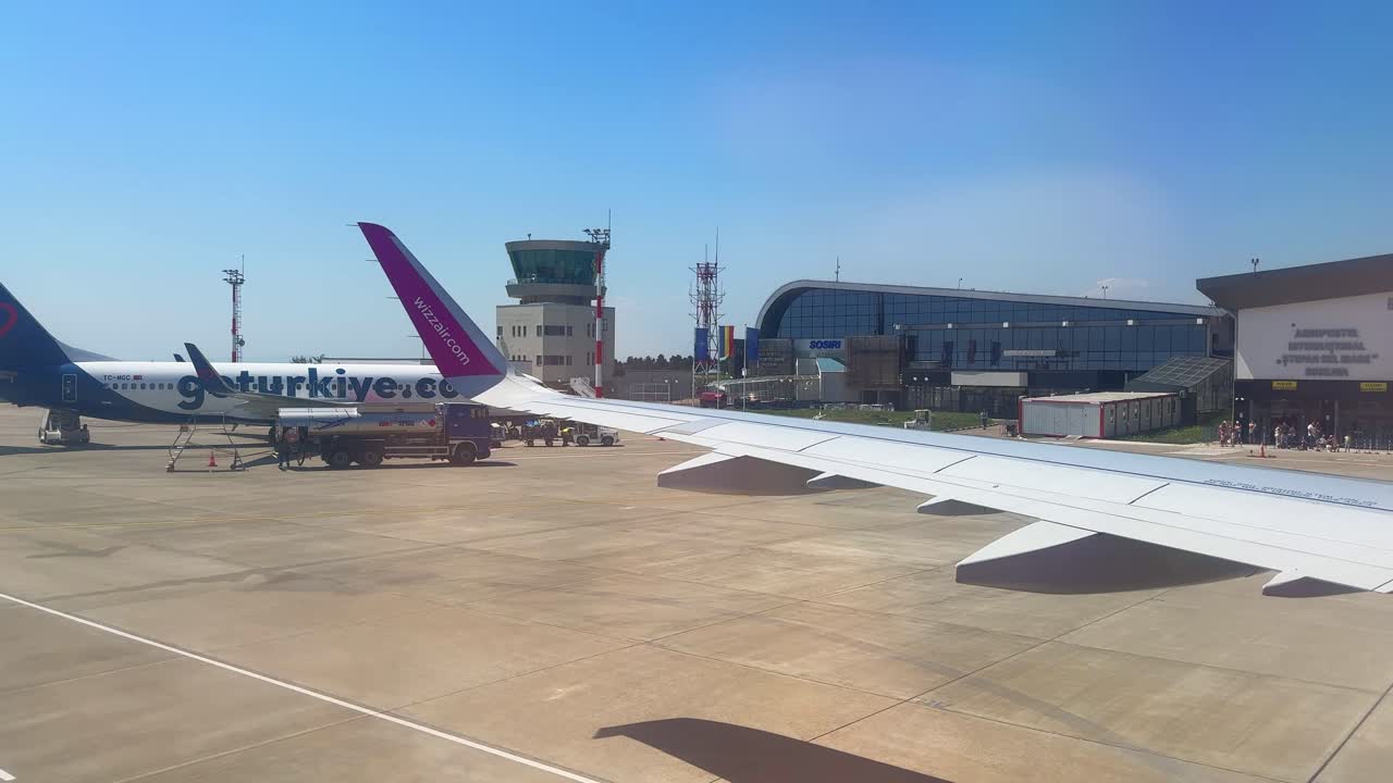 Plane window view takeoff Suceava Airport in Romania, fly airplane wing view