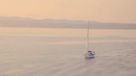 sunrise, sunset over open adriatic sea with coast visible in the background