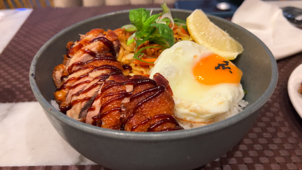 Thai crispy fried duck with fried egg, vegetables and white rice, delicious Asian food, 4K shot