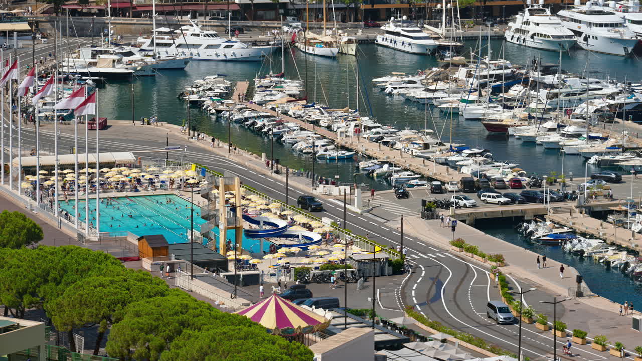 View of boats docked in the Monaco Marina with the skyline of the city on the background