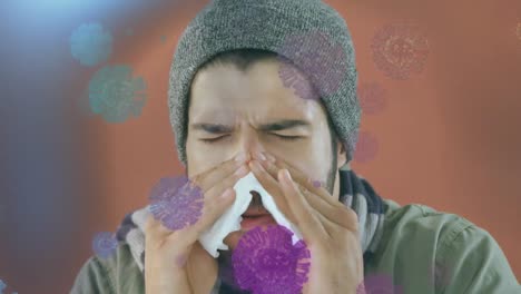 animation of macro covid-19 cells floating over caucasian man sneezing into a tissue