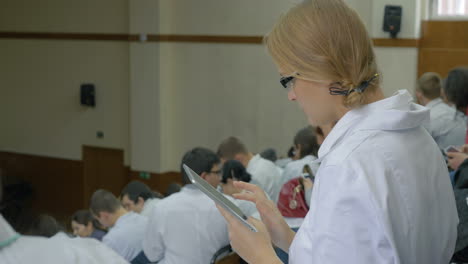 female medical student with pad on the lecture