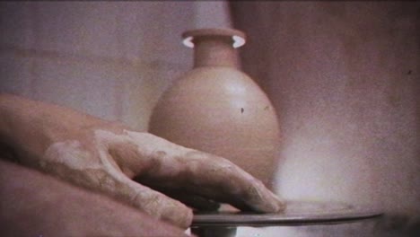 the potter makes a jug of clay. vintage effect. a man makes a vase on a potter's wheel