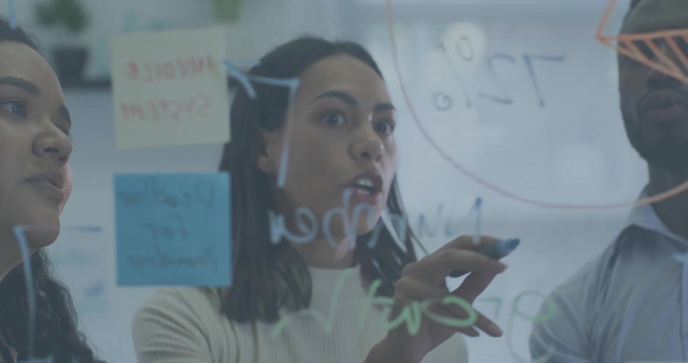 Woman writing notes on glass board for business planning, activating icons sweeping across board