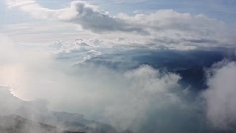 garda lake shines behind smoky clouds in morning mist, italian beauties, aerial