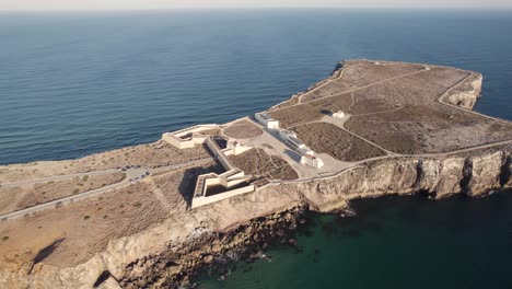 aerial view of fortaleza de sagres buttressed fortress with two tones deep blue and turquoise ocean, portugal