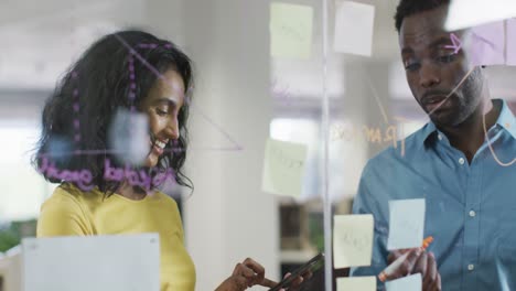 video of happy diverse businesswoman and businessman brainstorming in office