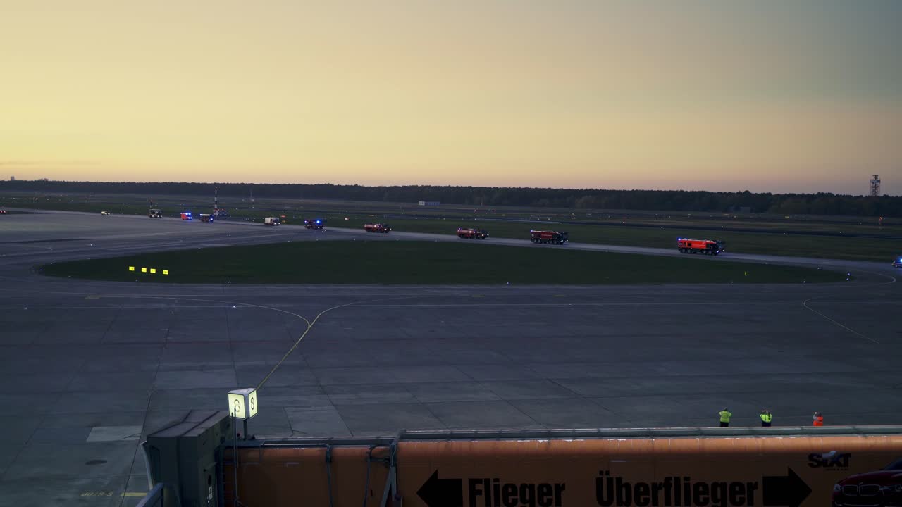 Airport fire brigade driving fast with sirens in ceremony at german Berlin airport Tegel (TXL), firefighters goodbye ceremony
