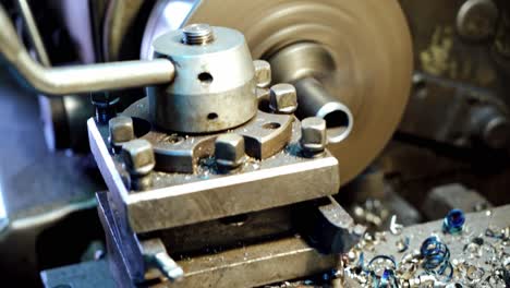 metallic lathe working at factory. operator machining part by cnc turning machine