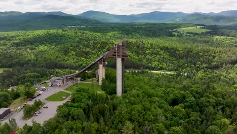 Approaching-aerial-view-of-Ski-Jump-towers-in-Lake-Placid,-New-York