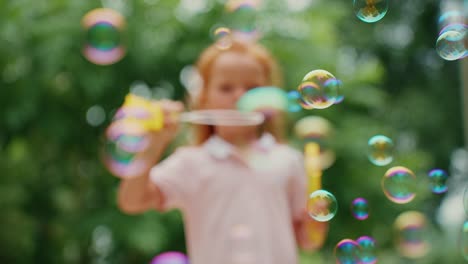 child playing with bubbles outdoors