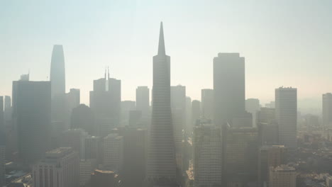 rising aerial shot over hazy downtown san francisco