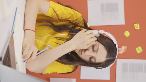 vertical video of girl child listening to music with headphones at home