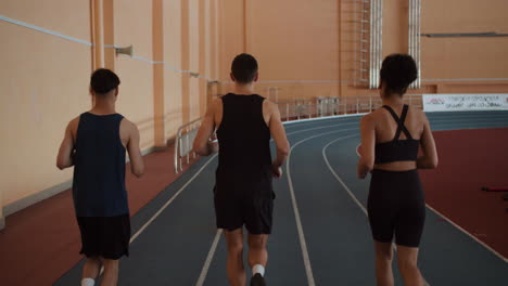 back view of athletes running