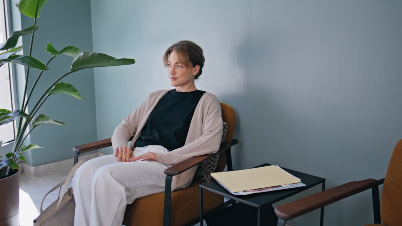 Patient sitting hall healthcare clinic. Relaxed lady waiting medical appointment