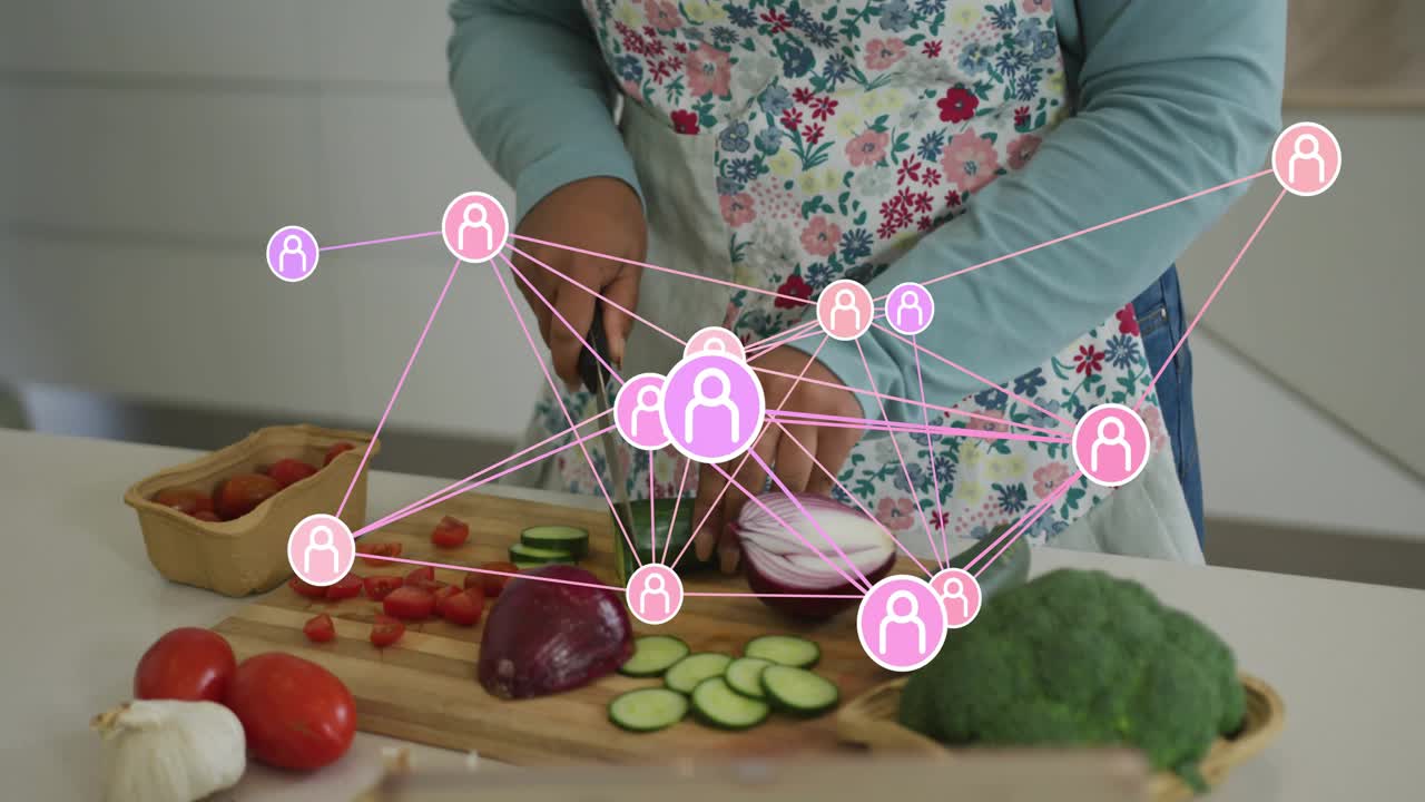 Network overlay emerging around cook initiating vegetable slicing, tomato dicing for culinary prep